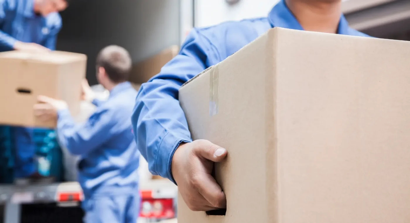 professional movers handling and transporting boxes during a move